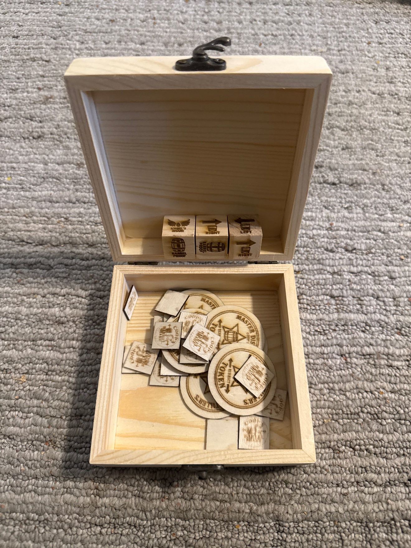 Coop's Barrel Share box open, showing the three engraved dice, game chips and Master Distiller's Tokens