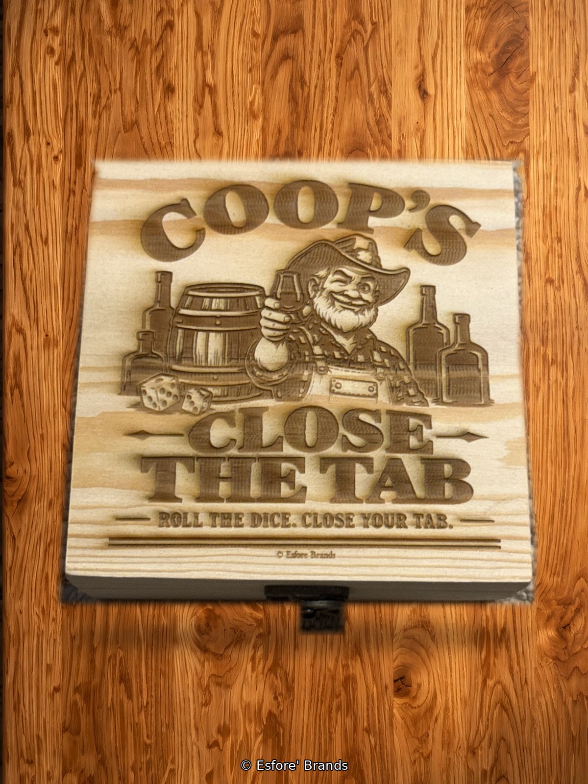 Coop's Close the Tab bourbon dice game in a laser-engraved wooden box, on a bar top