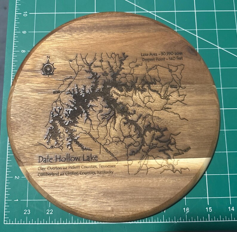Round wooden wall plaque laser engraved with a lake map