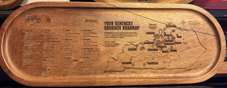 Laser-engraved wooden serving tray with the Kentucky bourbon roadmap and distillery list